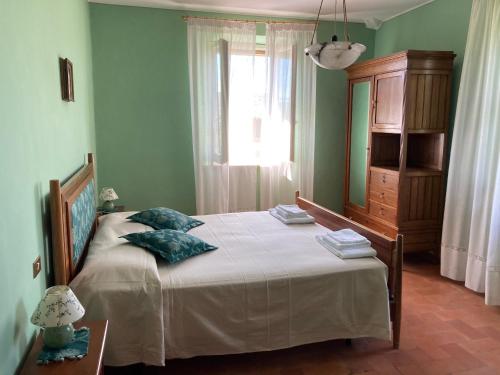 En eller flere senge i et værelse på Agriturismo Il Casale Grande