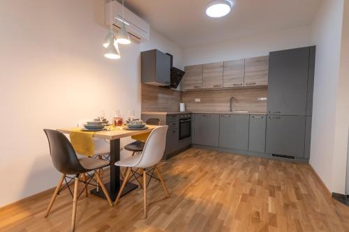 a kitchen with a table and chairs in a room at Apartment LaSiesta in Ptuj