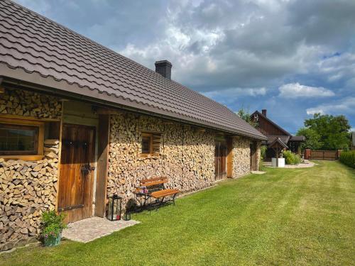 a stone building with a bench in front of it at INNA BAJKA in Nowy Berezów