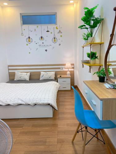 a bedroom with a bed and a desk and a chair at Trang Nguyen House in Da Lat