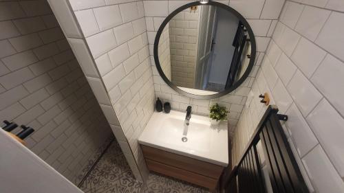 a bathroom with a sink and a mirror at Apartmán U Profesora in Staré Město