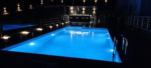 a large swimming pool with lights in a dark room at Paraiso Azul Villas in Áyios Dhimítrios