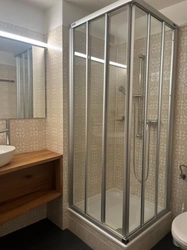 a bathroom with a shower and a sink at Residenz Majesta in Leukerbad
