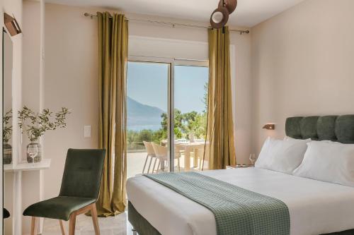 a bedroom with a bed and a chair and a window at Montagna & Mare villa in Kefallonia