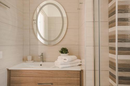 a bathroom with a sink and a mirror at Montagna & Mare villa in Kefallonia