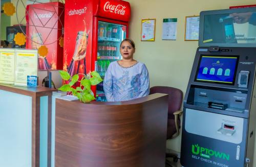 a woman standing in front of a cocacola machine at GS Budget Hotel Ampang in Ampang