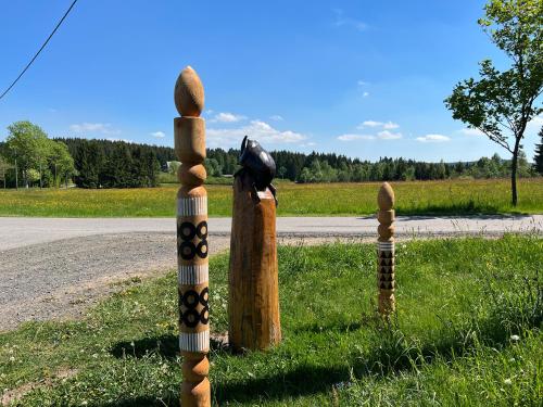 a couple of wooden posts with a bird sitting on top at Berghotel Talblick in Holzhau
