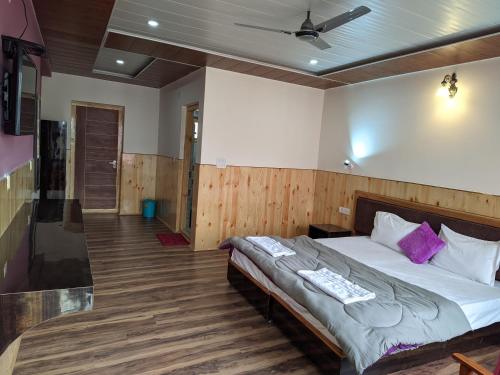 a bedroom with a bed and a ceiling at Chandan Guest House in Leh