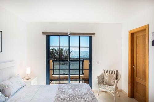a bedroom with a bed and a view of the ocean at Casa Marine in Lajita