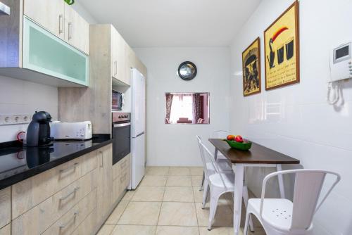 a kitchen with a table and a counter top at Casa sol in Vélez-Málaga
