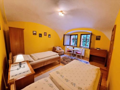 a room with two beds and a table with a table at Historical house in the center Levoča with parking in Levoča