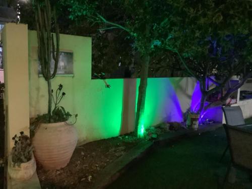 a fence with a green light on it at night at וילה נוף הרים שלומי in Shlomi
