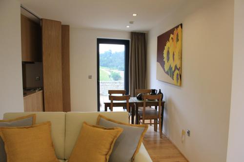 a living room with a couch and a table at Quinta de Fiães in Vilar de Maçada