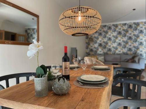 a dining room table with a bottle of wine and glasses at Apartment Colina Verde in Carvoeiro