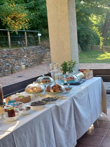 a table with a buffet of food on it at Open Cascina in Colico