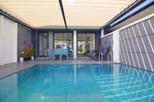 a swimming pool in the middle of a house at Juglans Suites in Fethiye