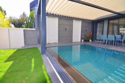 a swimming pool in the backyard of a house at Juglans Suites in Fethiye