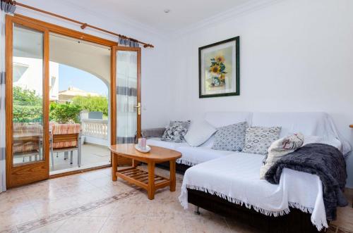 a living room with a couch and a table at YourHouse Ca Na Maria in Son Serra de Marina