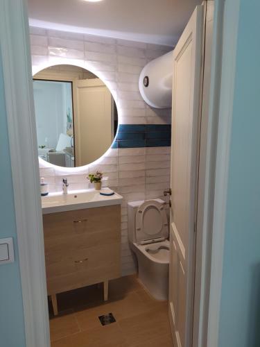 a bathroom with a toilet and a sink and a mirror at Emerald Blue in Skiathos Town