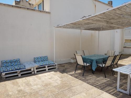 a patio with a table and chairs and a couch at CasaCalò in Gallipoli