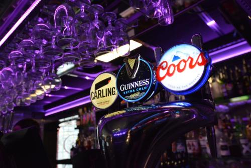 a bar with a bunch of signs hanging from a ceiling at The George Hotel in Whitby