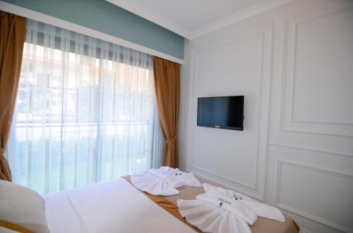 a bedroom with a bed with towels on it at Juglans Suites in Fethiye