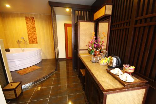 ein Badezimmer mit einer großen Badewanne und einem Waschbecken in der Unterkunft CM Night Bazaar Boutique Hotel โรงแรม ซี เอ็ม ไนท์บาซาร์ บูทีค - SHA Plus Certified in Chiang Mai