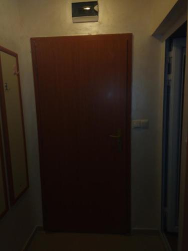 a brown door in a room with a window at Apartments Dani in Pomorie