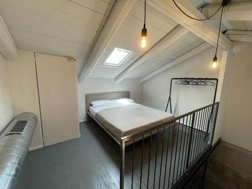 a small room with a bed in a attic at Loft 56 in Porto SantʼElpidio