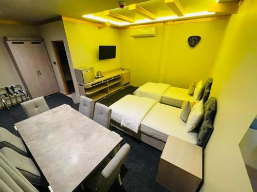 a hotel room with a bed and a dining table at Daraysh Hotel in Sharjah