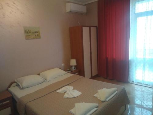 a bedroom with a bed with two towels on it at Apartments Dani in Pomorie