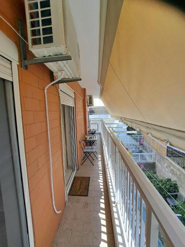a balcony of a building with a heater at Periklis House in Ixia