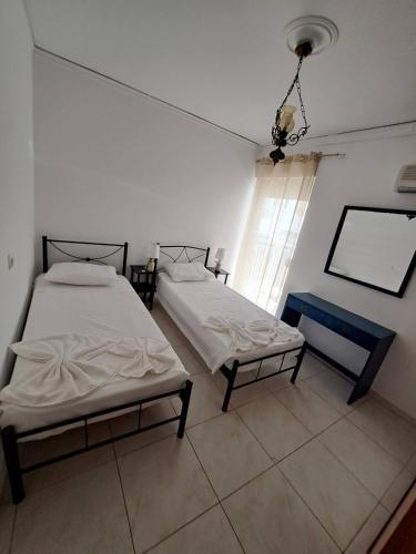 a room with two beds and a window in it at Periklis House in Ixia