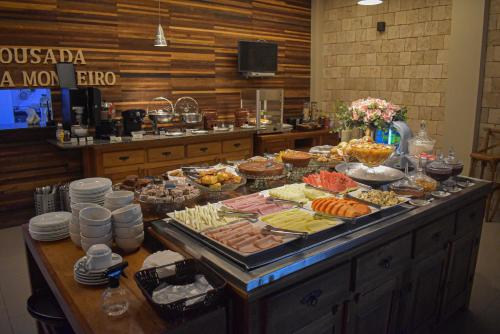 a buffet with many different types of food on a table at Pousada Maria Monteiro Tiradentes in Tiradentes