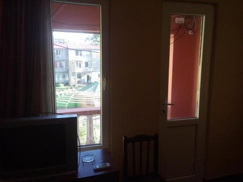 a room with a door and a window and a table at Guest House Rusalka in K'obulet'i