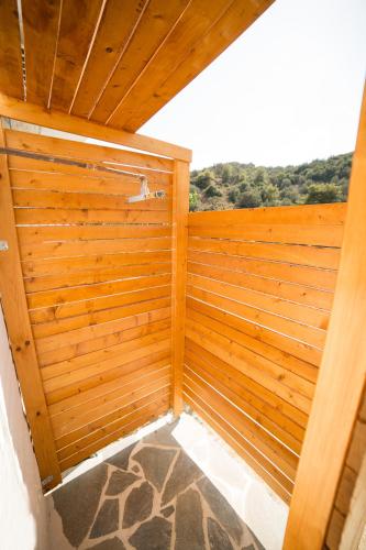 a wooden room with a wooden wall at AZALEA - Modern studio with sea view in Galatas