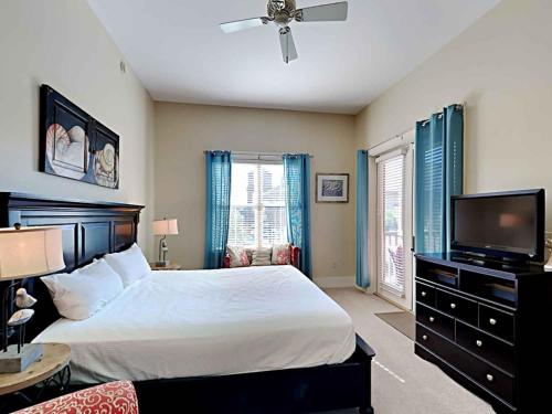 a bedroom with a bed and a flat screen tv at Redfish Village m1-218 in Blue Mountain Beach