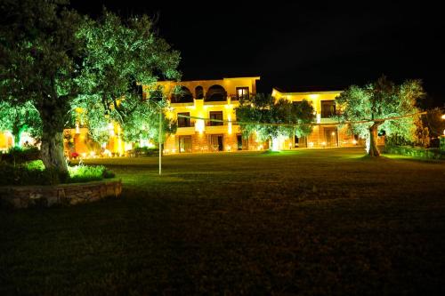 a building lit up at night with trees in front at Saint George Sithonia in Neos Marmaras