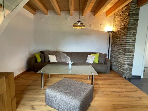 a living room with a couch and a table at Ferienhaus Eifelherz in Simmerath