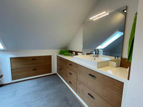 a bathroom with a sink and a mirror at Ferienhaus Eifelherz in Simmerath