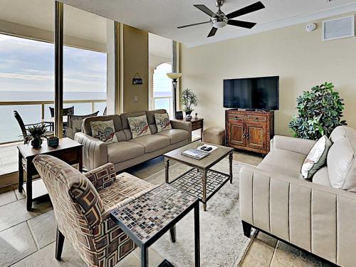 a living room with a couch and a tv at Beach Club #1605C in Pensacola Beach