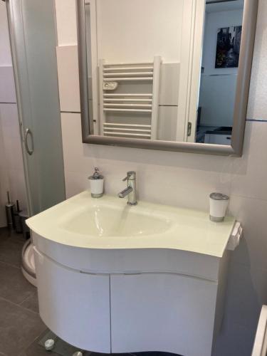 a bathroom with a white sink and a mirror at Studio Villa la Cigale avec grande Terrasse in Menton