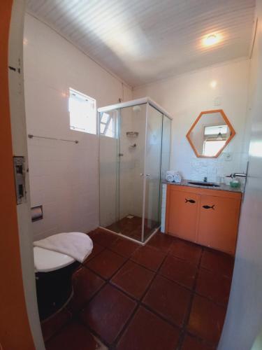 een badkamer met een douche, een toilet en een wastafel bij Pousada L'escale in Búzios