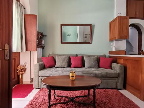 a living room with a couch and a table at Ξενώνας Μυρτώ in Andritsaina