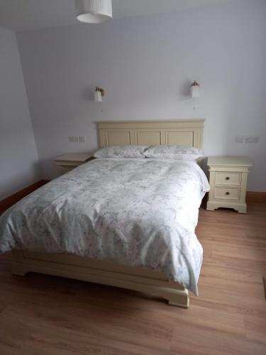 a bedroom with a large bed and two night stands at Jack's House in Glenties