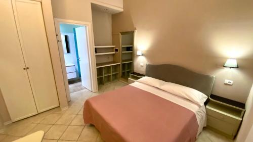 a small room with a bed and a bathroom at Residence Al Lago in Castiglione del Lago