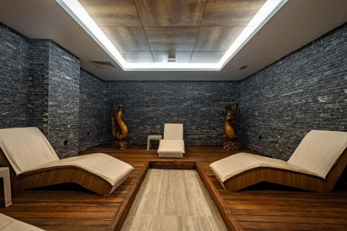 a room with two chairs and a brick wall at PEARLY HOTEL in Antalya
