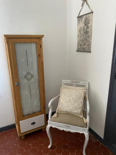 a chair and a cabinet in a room at La Bastide de Jean Maison de charme dans un domaine equestre privé in Grasse