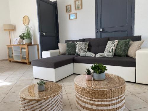 a living room with a couch and two tables at La Bastide de Jean Maison de charme dans un domaine equestre privé in Grasse