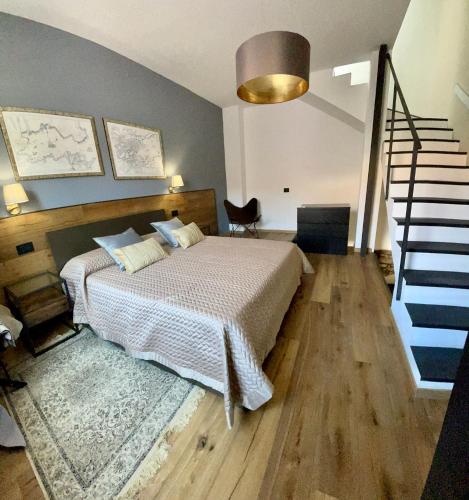 a bedroom with a bed and a staircase and a stair case at Suite 29A Olbia Center in Olbia